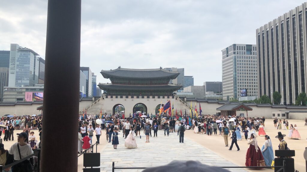 Gwanghwamun seen from inside Gyeongbokgung with visitors in the courtyard